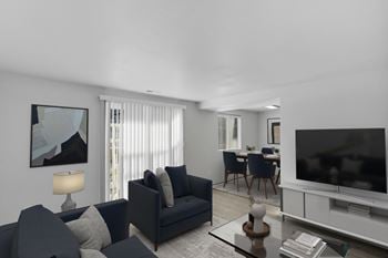 A modern living room with a dark blue sofa and a television.